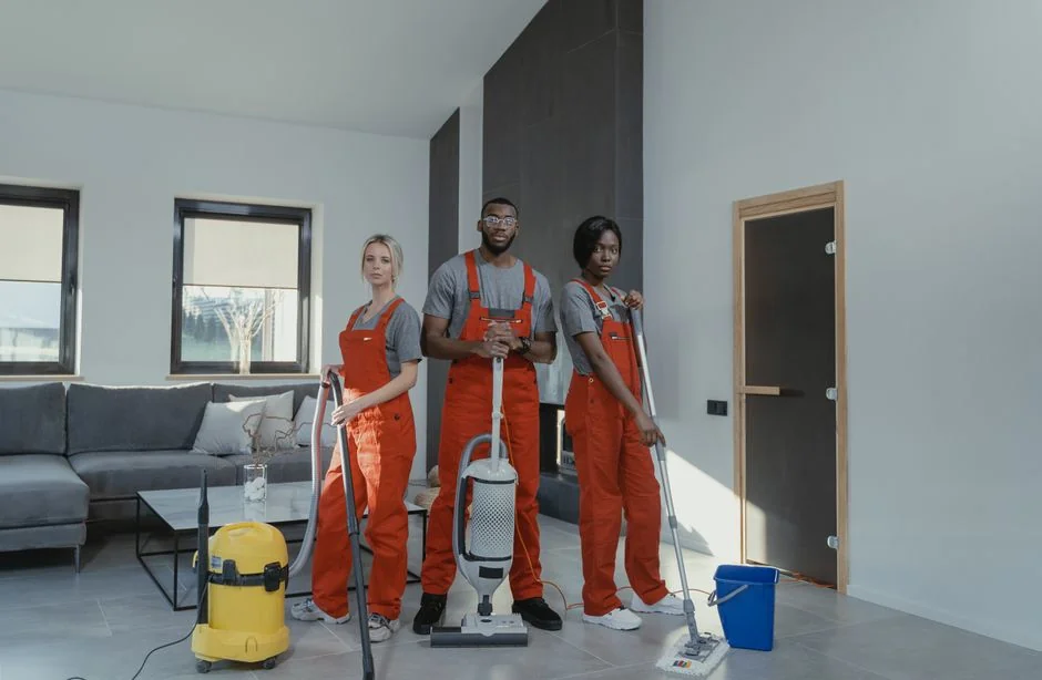 why-choose-us-03 a-woman-in-a-green-shirt-and-black-gloves-vacuuming-a-gray-ottoman-5txz228u4eo